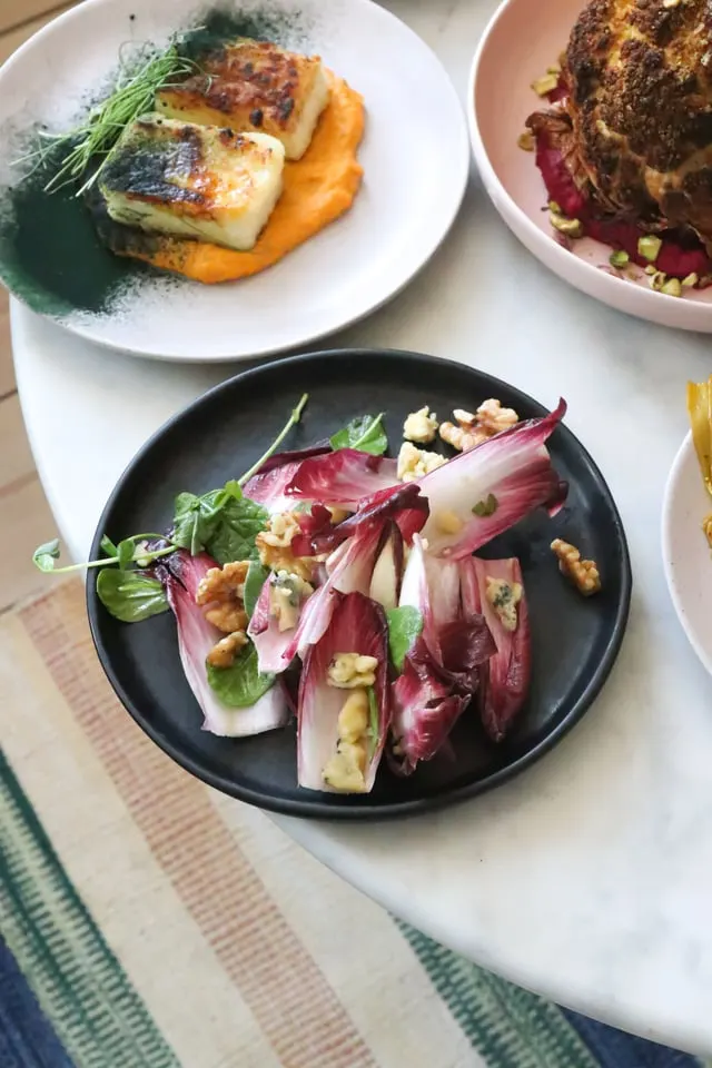 Plated fish with endive walnut salad