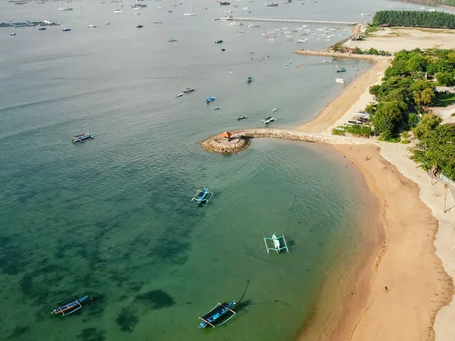 Jimbaran Bay's curved beach and fishing boats from the air