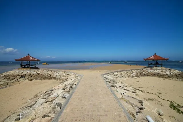 Sanur's breakwater path between two sea gazebos, deep blue sky (only 2376 px wide)