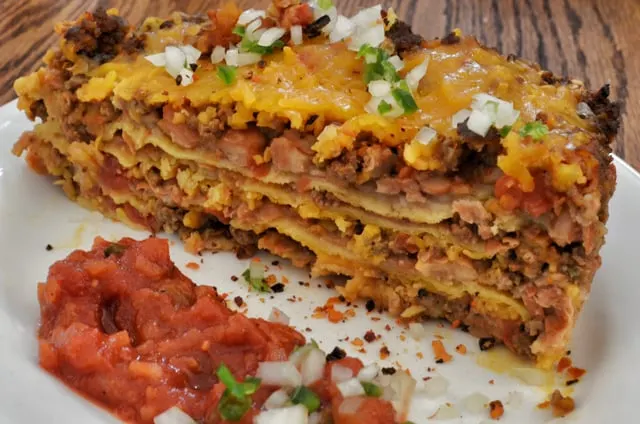 A slice of Tex-Mex tortilla lasagne with salsa