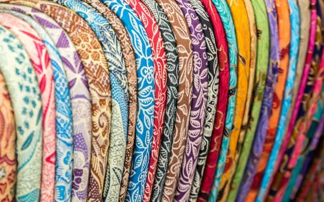 Rows of colourful batik sarongs at Ubud Art Market