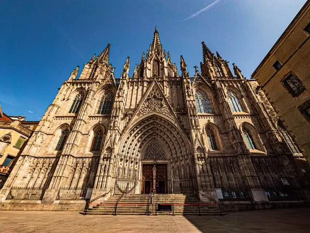 Barcelona Cathedral's Gothic front in sunlight, blue sky