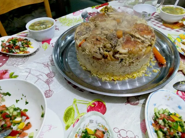 Maqluba, an upturned rice dish, on a serving tray