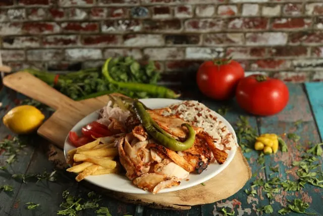 A doner plate with fries and salad