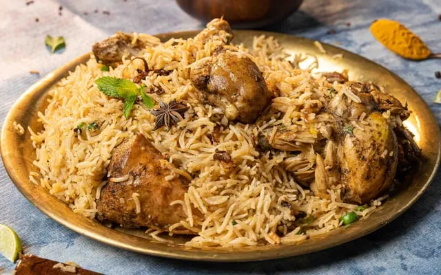 Chicken biryani on a brass platter