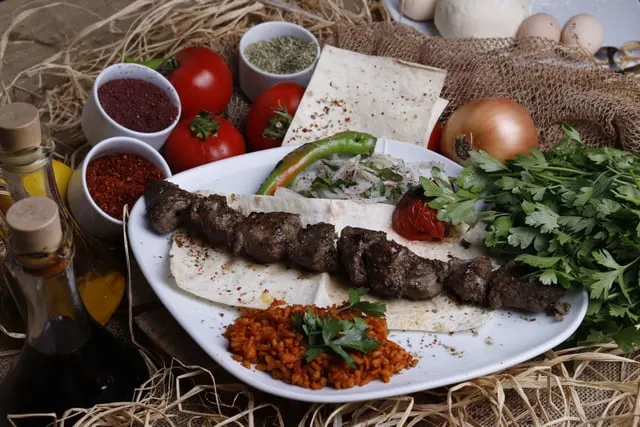 Grilled Adana kebab with salad and dips