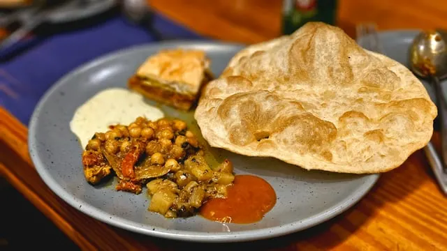 Chole bhature with pickle and onion