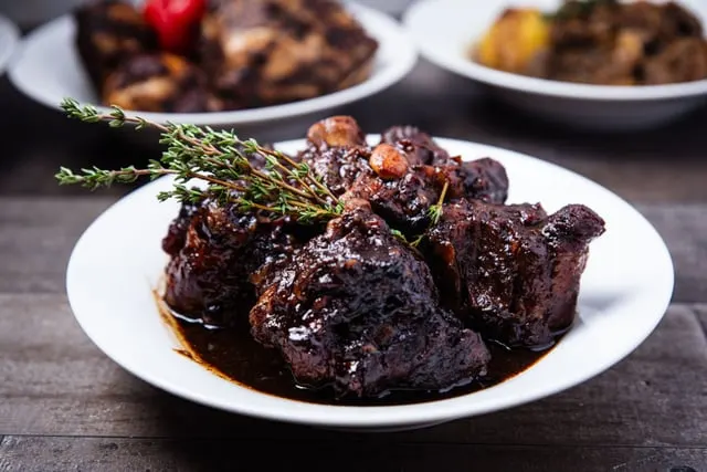 Braised oxtail in a dark glossy sauce with thyme