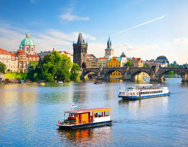 Photo: givaga / Shutterstock Charles Bridge, the Old Town Bridge Tower and a river boat on the Vltava, sunny