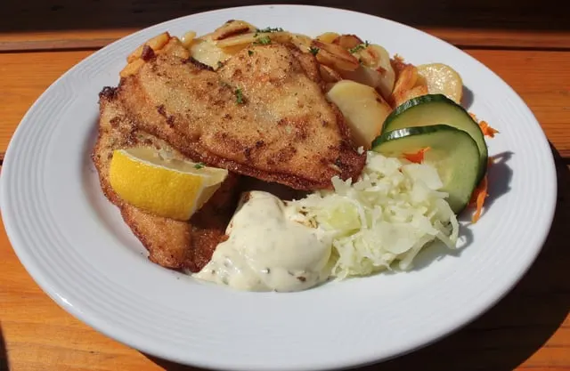 Fried fish fillets with potatoes and salad