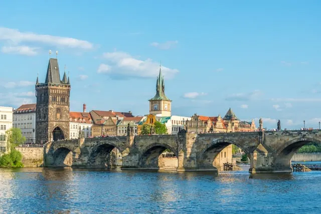Charles Bridge and the Old Town Bridge Tower from the river, blue sky