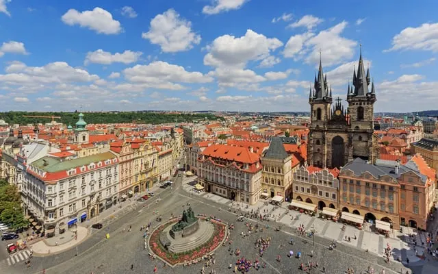 Old Town Square and the Týn Church from above, blue sky with cloud