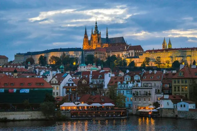 Prague Castle above the riverside houses, blue sky with cloud