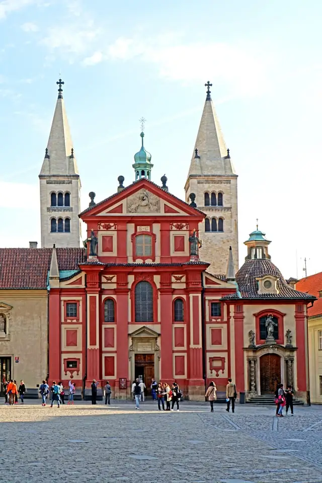 St George's Basilica's red Baroque front and white towers, blue sky