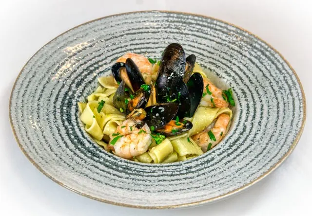 Typical mixed pasta with mussels, smoked tomato and preserved lemon