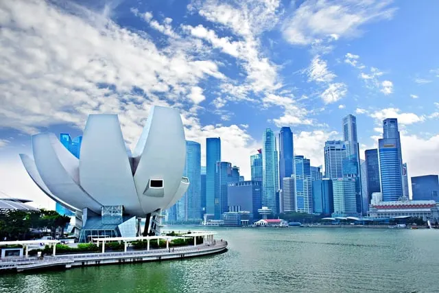 1965937 / Pixabay / Pixabay Content License The ArtScience Museum and the Marina Bay skyline under a blue sky